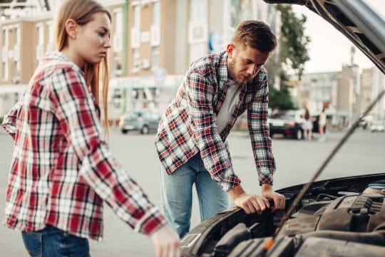 Car Breakdown Couple Try To Jump Start a Car