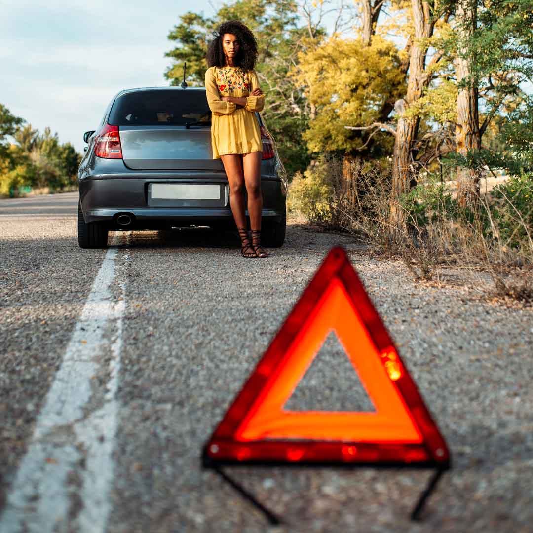 Woman with car break down waiting for a jump start